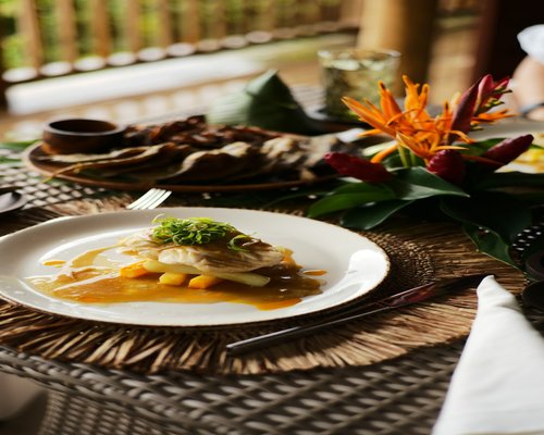 A rustic dining table set with healthy, colorful tropical food